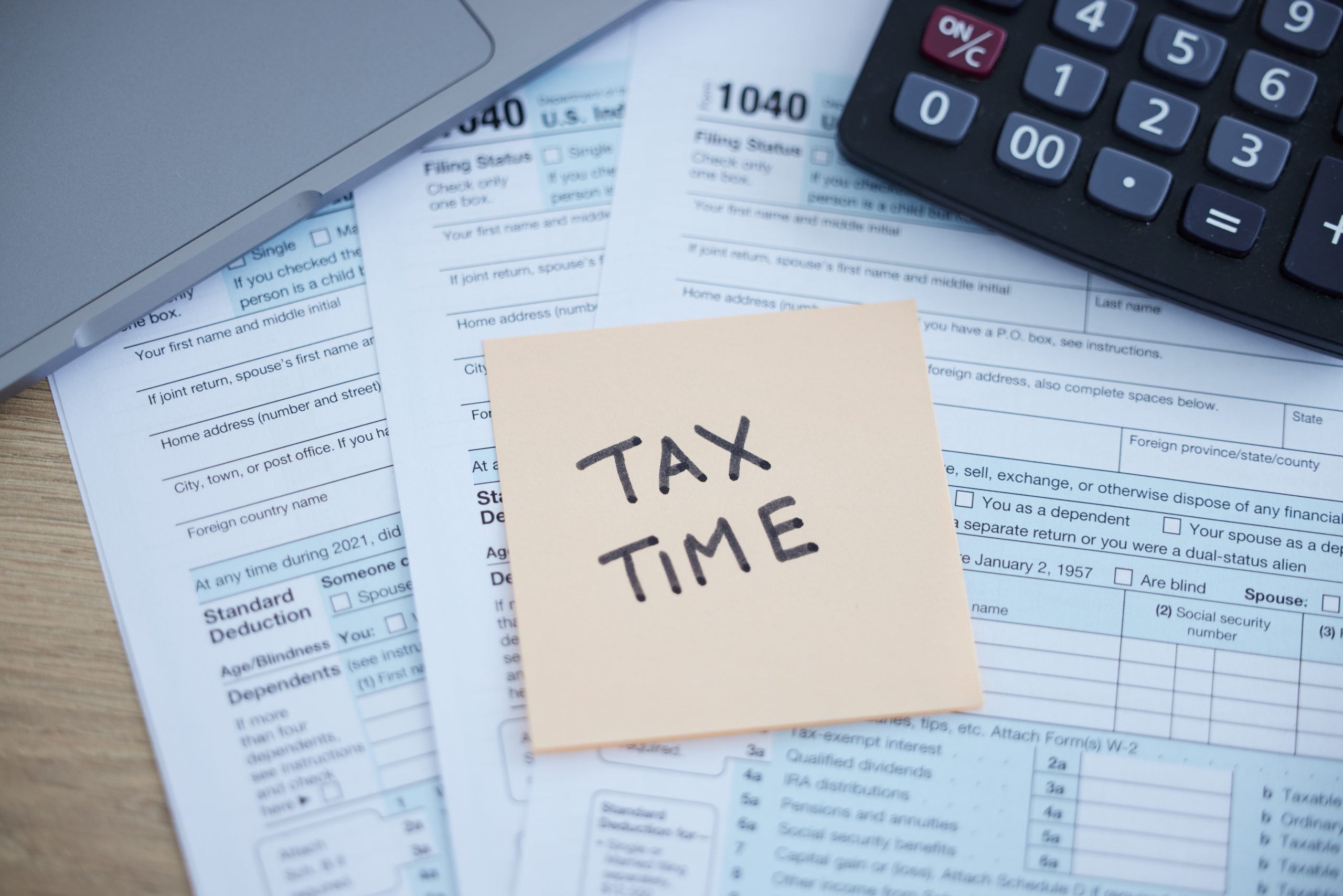 tax-time photo of tax forms and a calculator